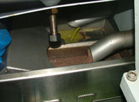 Olio extravergine di oliva and water leaving the cold press extraction machine